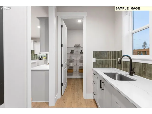 a kitchen with a sink and refrigerator