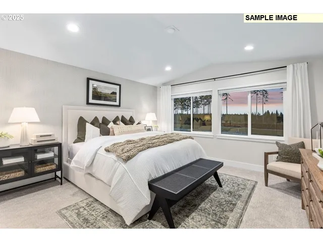 a bedroom with a bed and a large window