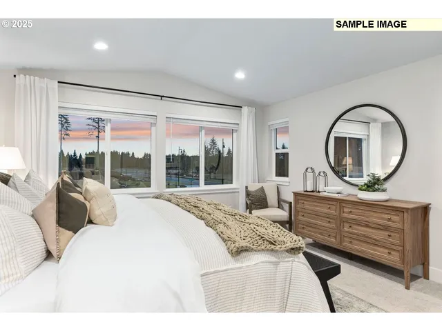 a living room with furniture a mirror and a large window