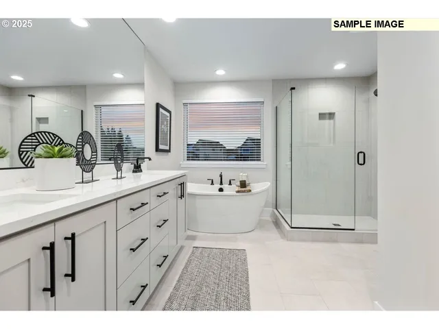 a bathroom with a double vanity sink a toilet a mirror and shower