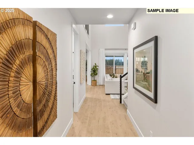 a view of a hallway with wooden floor and a dining room