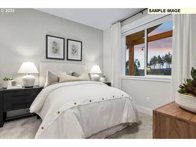 a bedroom with a bed and a large window