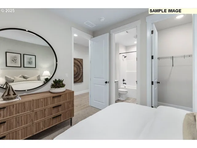 a bedroom with a bed and a dresser