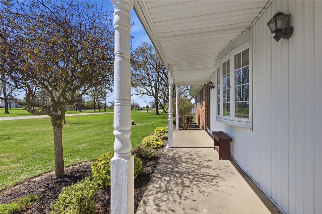 6718 Old Columbus Road South Vienna, OH 45369 - Photo 5 of 33 This inviting porch welcomes you to a home surrounded by lush greenery and open spaces.