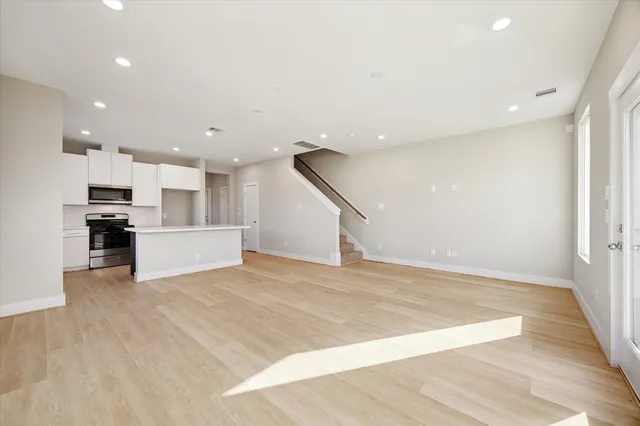a view of kitchen with wooden floor and electronic appliances