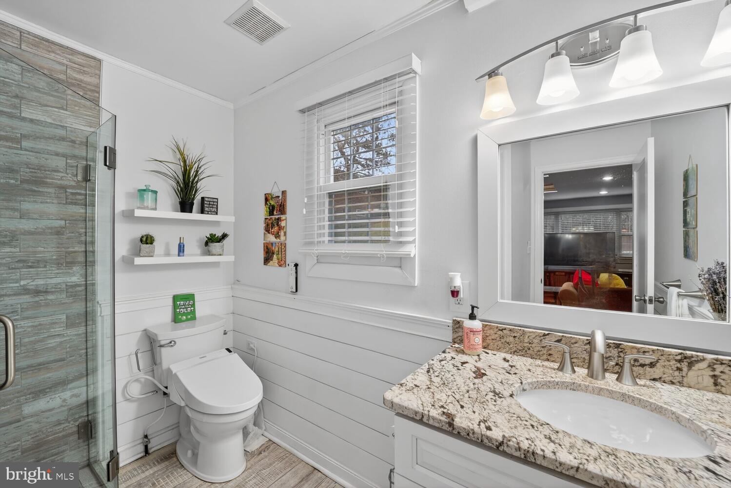 1432 35th Street Southeast Washington, DC 20020 - Photo 16 of 36 a bathroom with a granite countertop toilet sink and mirror