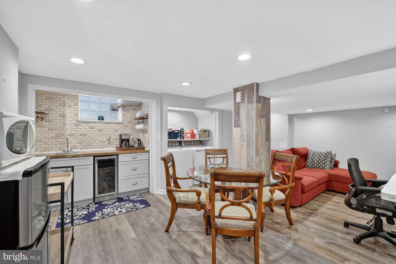 1432 35th Street Southeast Washington, DC 20020 - Photo 22 of 36 a kitchen with a table chairs refrigerator and cabinets