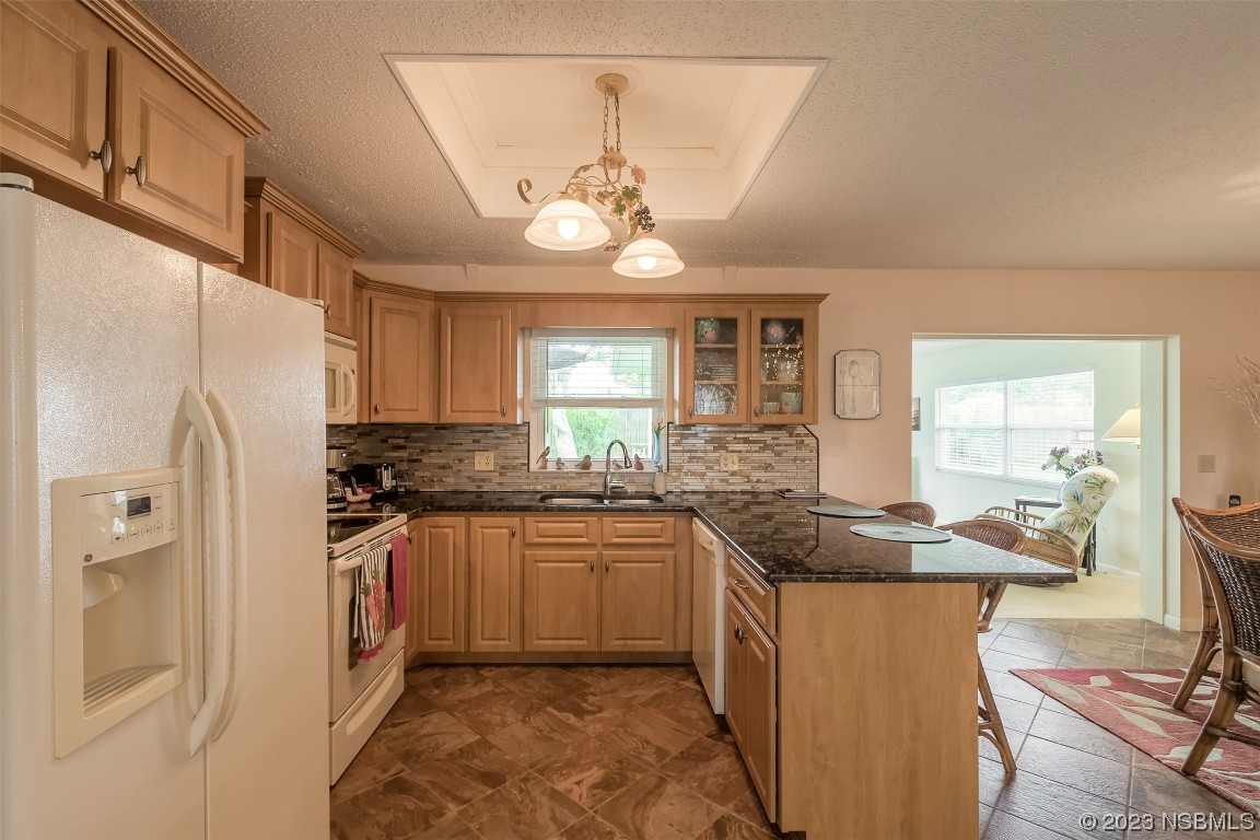 2828 Pine Tree Drive Edgewater, FL 32141 - Photo 11 of 38 a kitchen with stainless steel appliances granite countertop a sink a stove and refrigerator