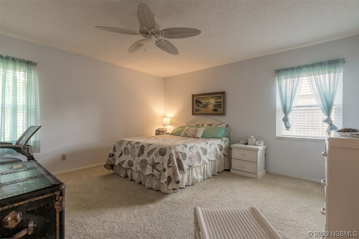 2828 Pine Tree Drive Edgewater, FL 32141 - Photo 16 of 38 a bedroom with a bed and a window