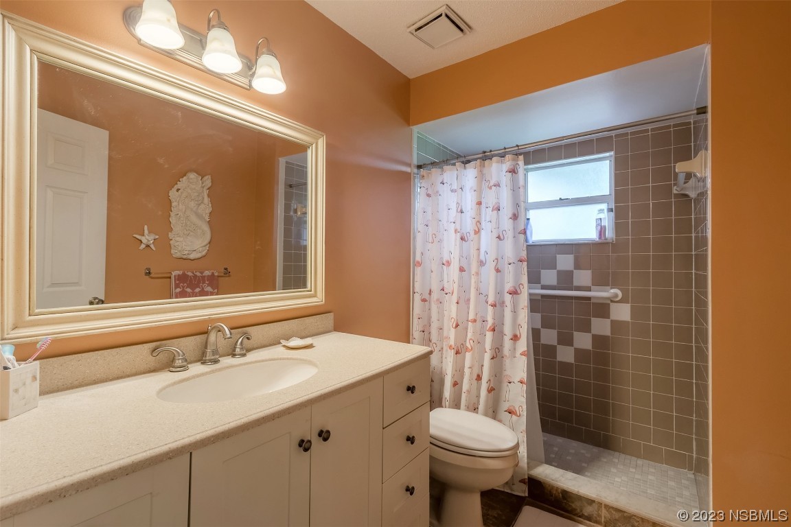 2828 Pine Tree Drive Edgewater, FL 32141 - Photo 20 of 38 a bathroom with a sink toilet and shower