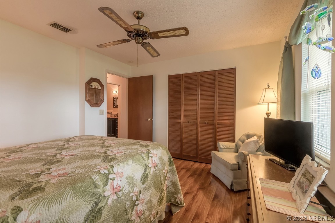2828 Pine Tree Drive Edgewater, FL 32141 - Photo 21 of 38 a bedroom with a bed and a flat screen tv