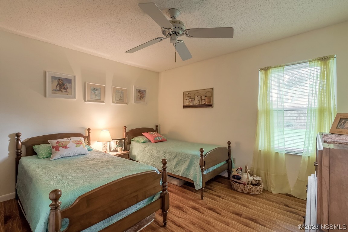 2828 Pine Tree Drive Edgewater, FL 32141 - Photo 22 of 38 a bedroom with two beds and wooden floor