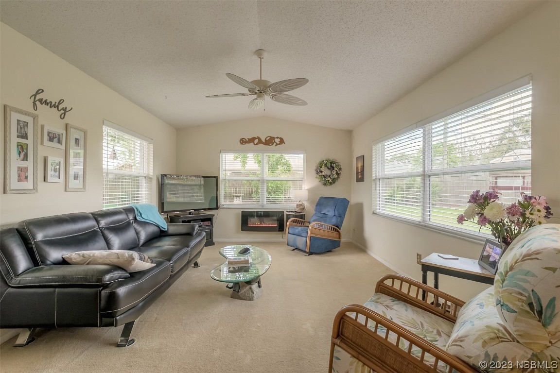 2828 Pine Tree Drive Edgewater, FL 32141 - Photo 26 of 38 a living room with furniture and a large window