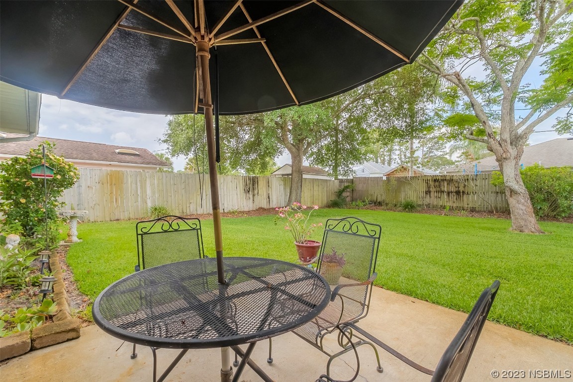 2828 Pine Tree Drive Edgewater, FL 32141 - Photo 28 of 38 a view of an chairs and table in patio