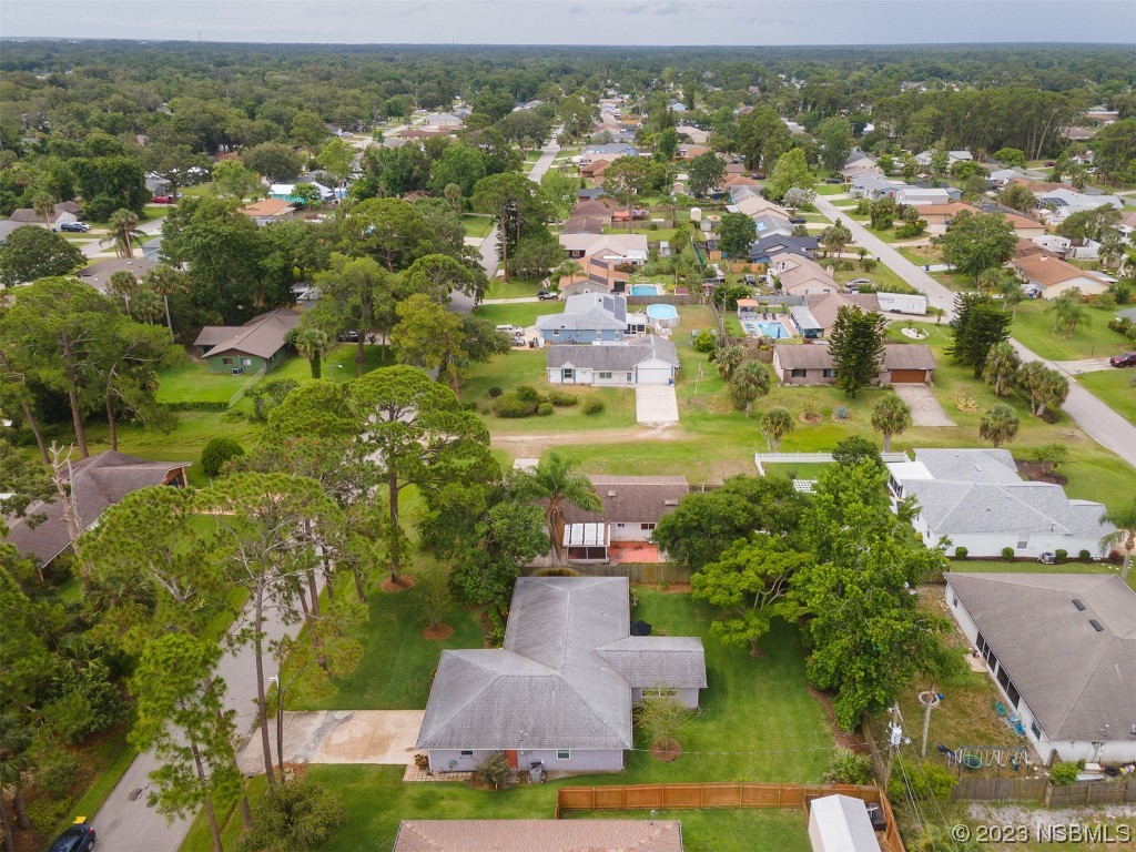 2828 Pine Tree Drive Edgewater, FL 32141 - Photo 33 of 38 an aerial view of residential houses with outdoor space and trees