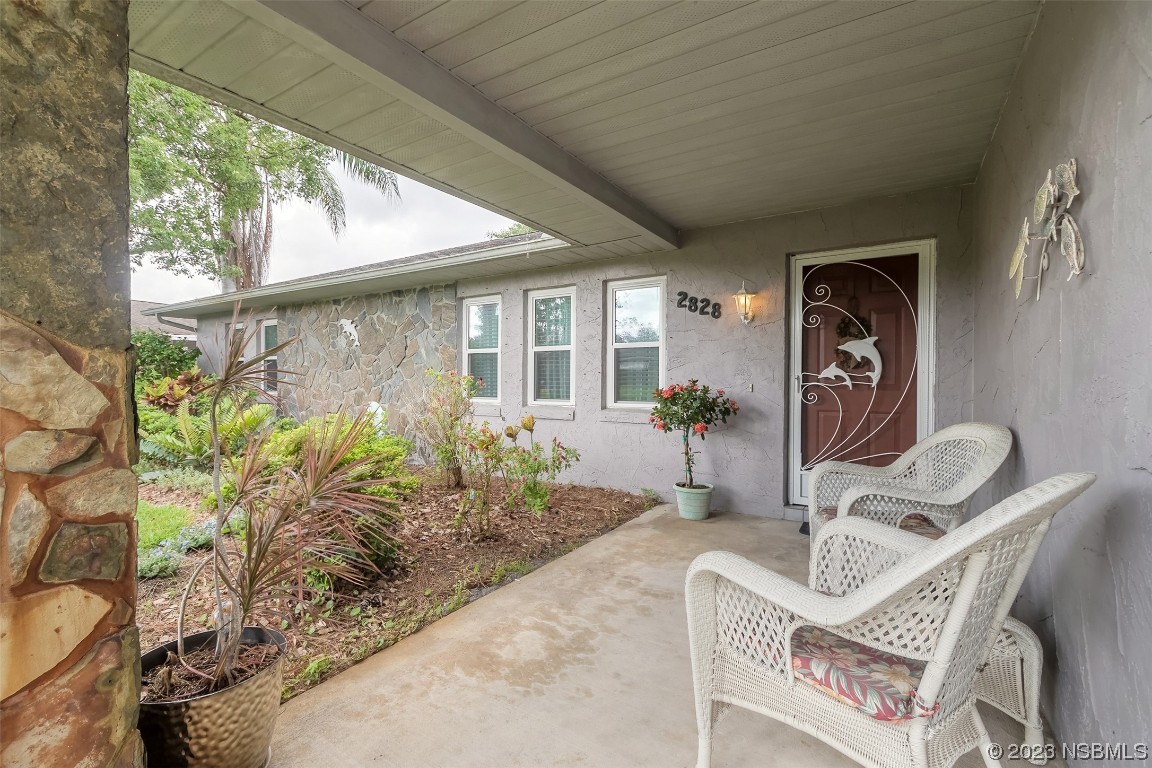 2828 Pine Tree Drive Edgewater, FL 32141 - Photo 4 of 38 a front view of a house with garden