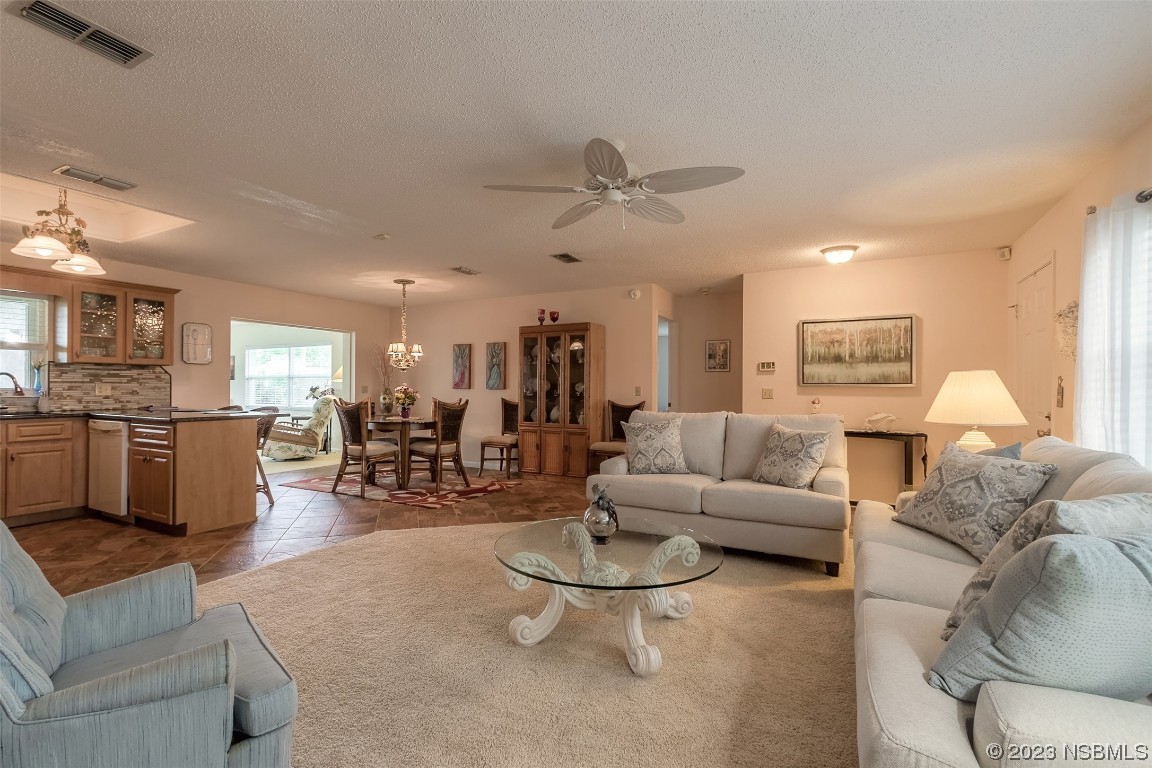 2828 Pine Tree Drive Edgewater, FL 32141 - Photo 5 of 38 a living room with furniture and kitchen view