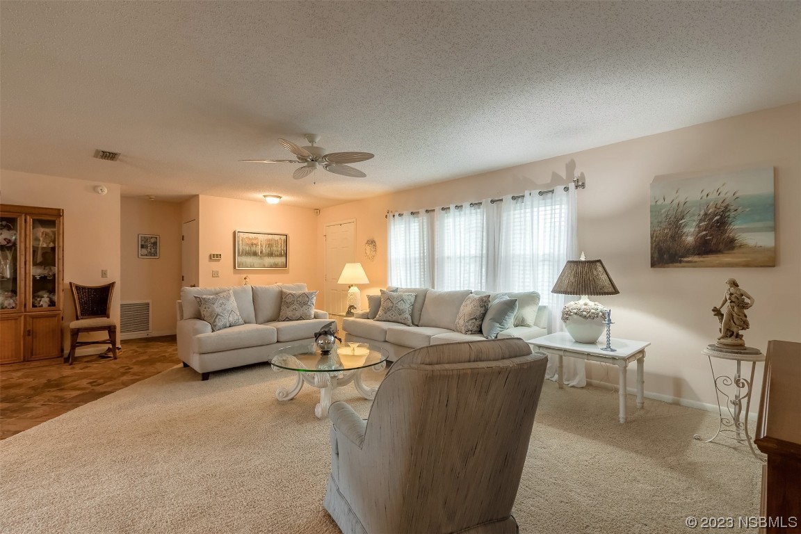 2828 Pine Tree Drive Edgewater, FL 32141 - Photo 6 of 38 a living room with furniture and a wooden floor