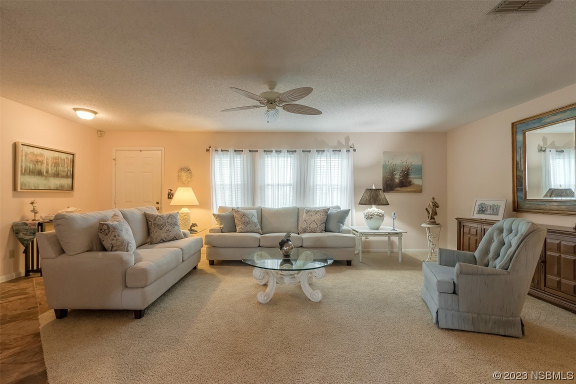 2828 Pine Tree Drive Edgewater, FL 32141 - Photo 7 of 38 a living room with furniture and a large window
