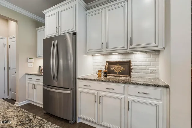 a kitchen with stainless steel appliances granite countertop a refrigerator sink and cabinets
