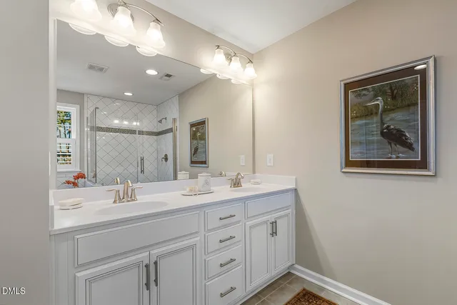 a bathroom with a double vanity sink and a mirror