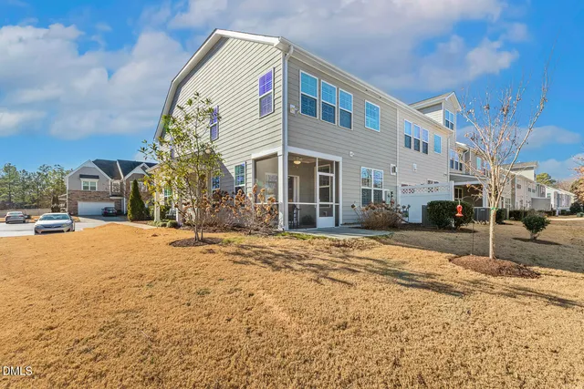 a view of a house with backyard and sitting area