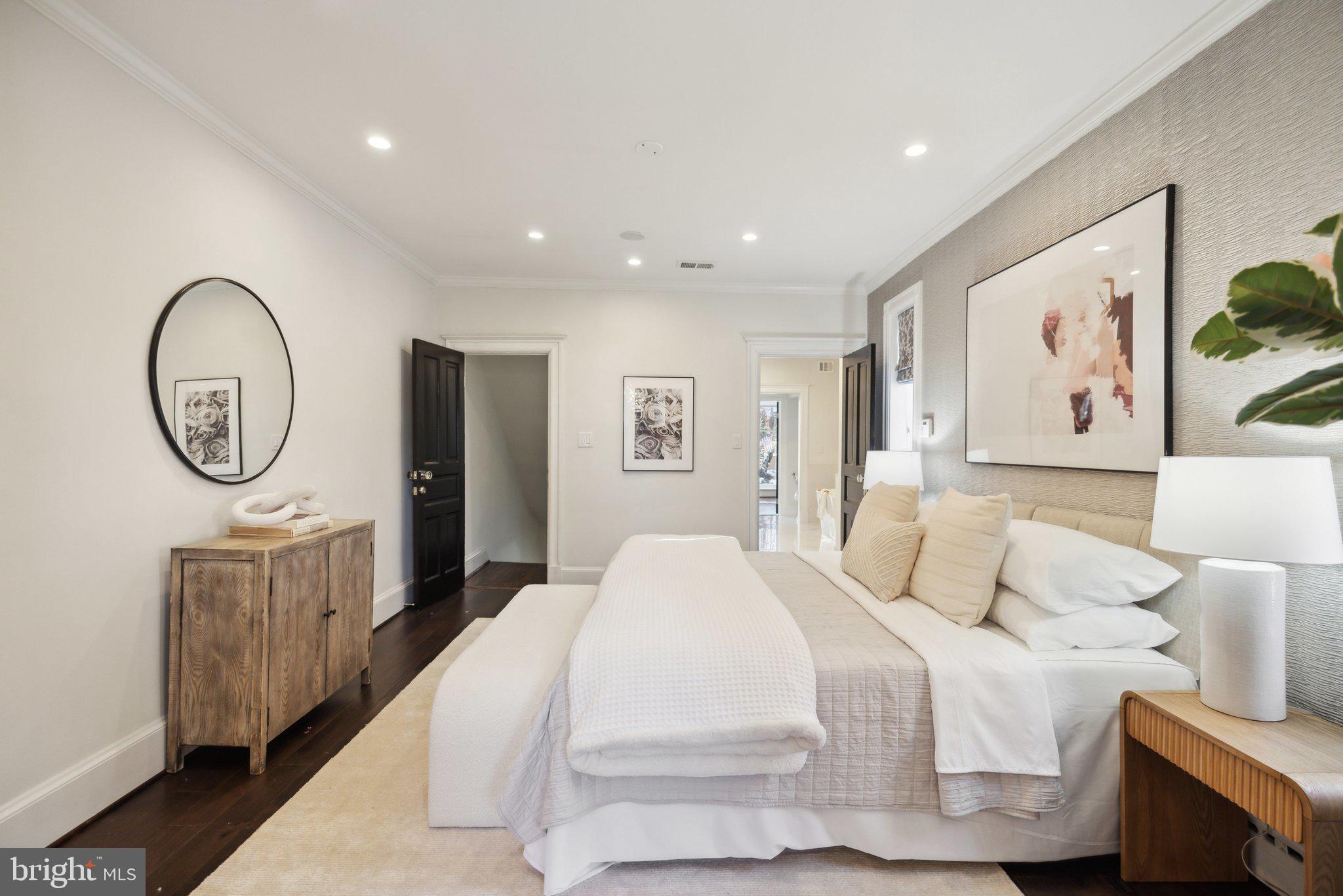 1527 31st Street Northwest Washington, DC 20007 - Photo 13 of 29 a spacious bedroom with a bed a mirror and a table