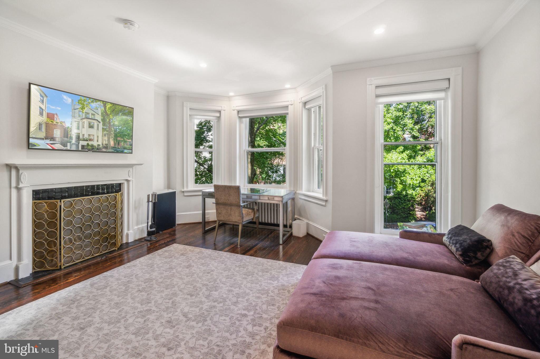 1527 31st Street Northwest Washington, DC 20007 - Photo 19 of 29 a bedroom with furniture and a fireplace