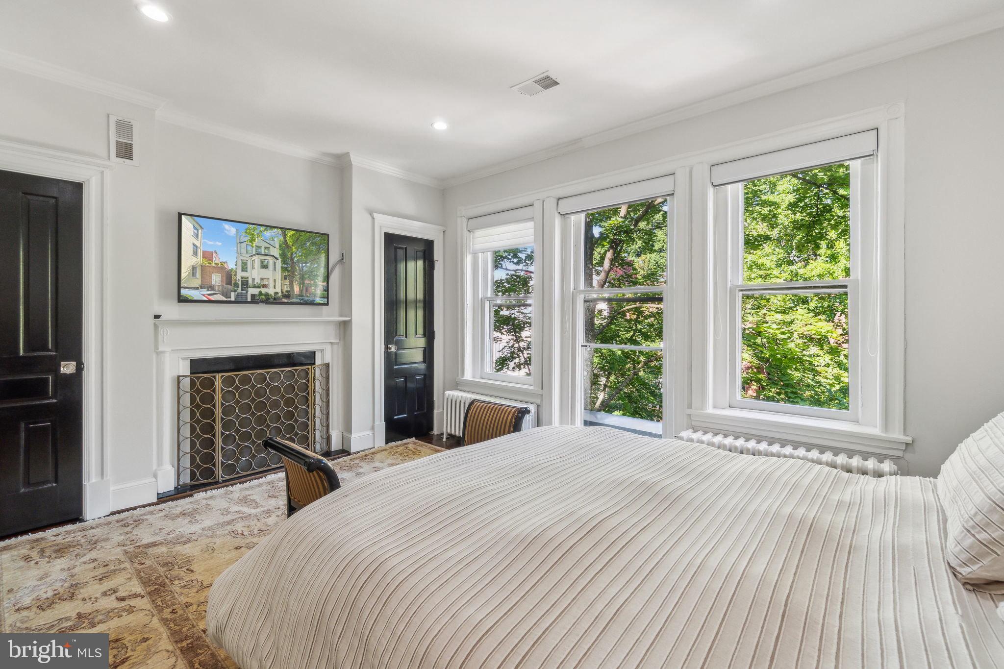 1527 31st Street Northwest Washington, DC 20007 - Photo 20 of 29 a bedroom with a large bed and a large window