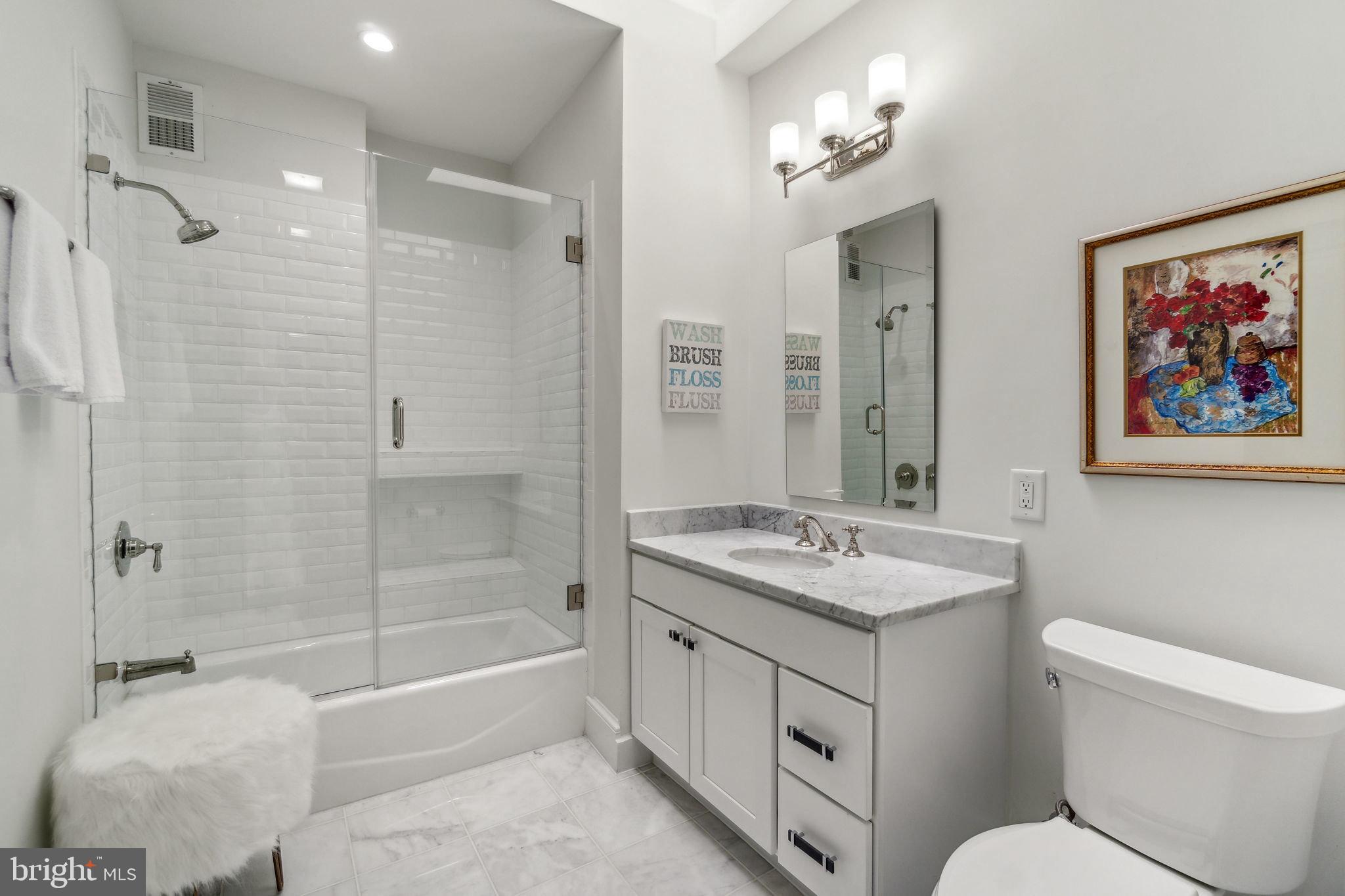 1527 31st Street Northwest Washington, DC 20007 - Photo 21 of 29 a bathroom with a granite countertop sink toilet and shower