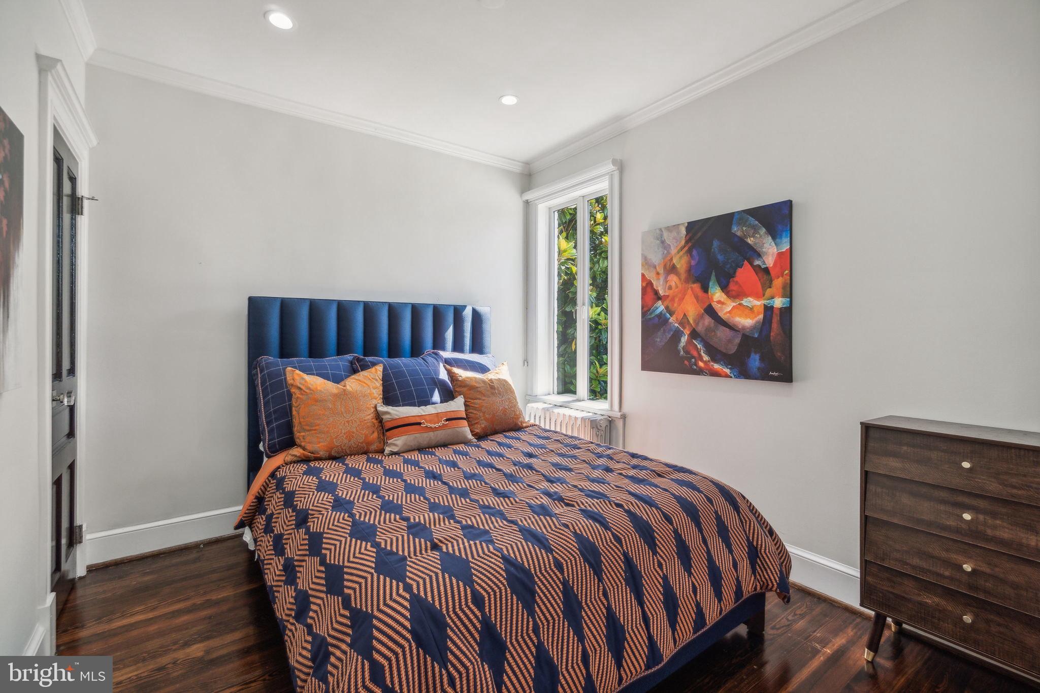 1527 31st Street Northwest Washington, DC 20007 - Photo 22 of 29 a bedroom with a bed and painting on the wall