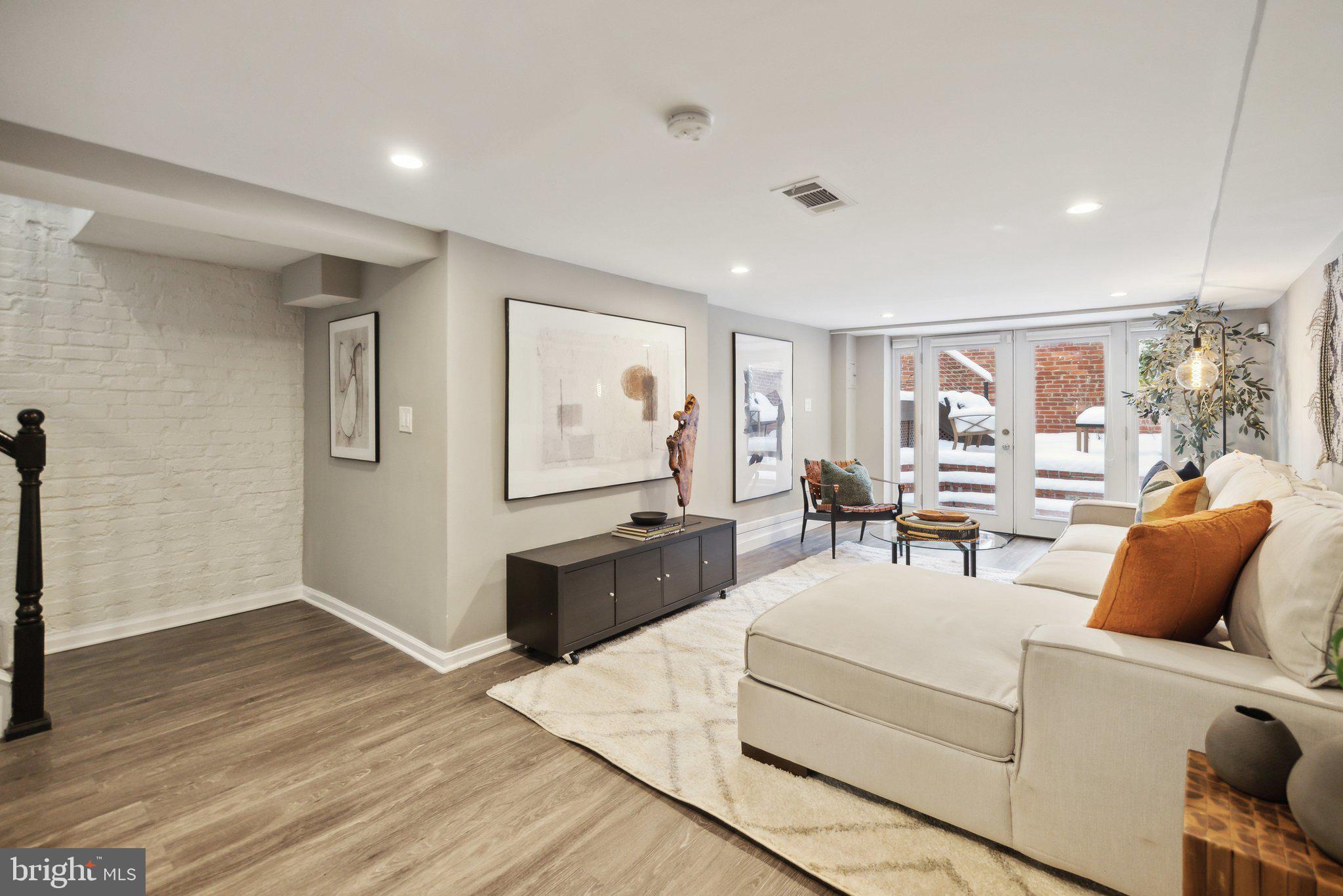 1527 31st Street Northwest Washington, DC 20007 - Photo 23 of 29 a living room with furniture and a flat screen tv