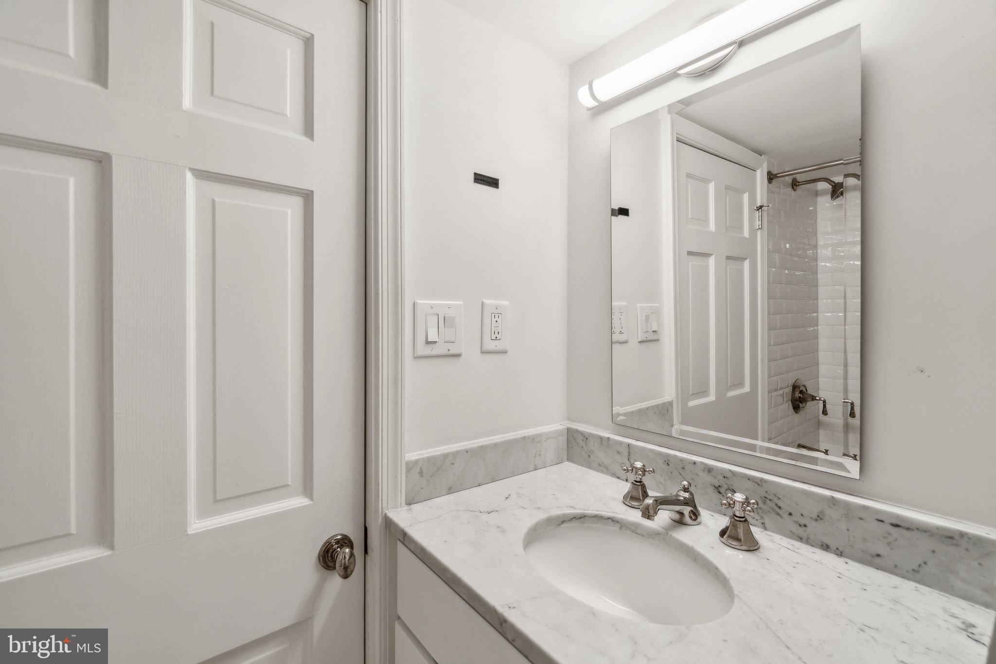 1527 31st Street Northwest Washington, DC 20007 - Photo 26 of 29 a bathroom with a sink and a mirror