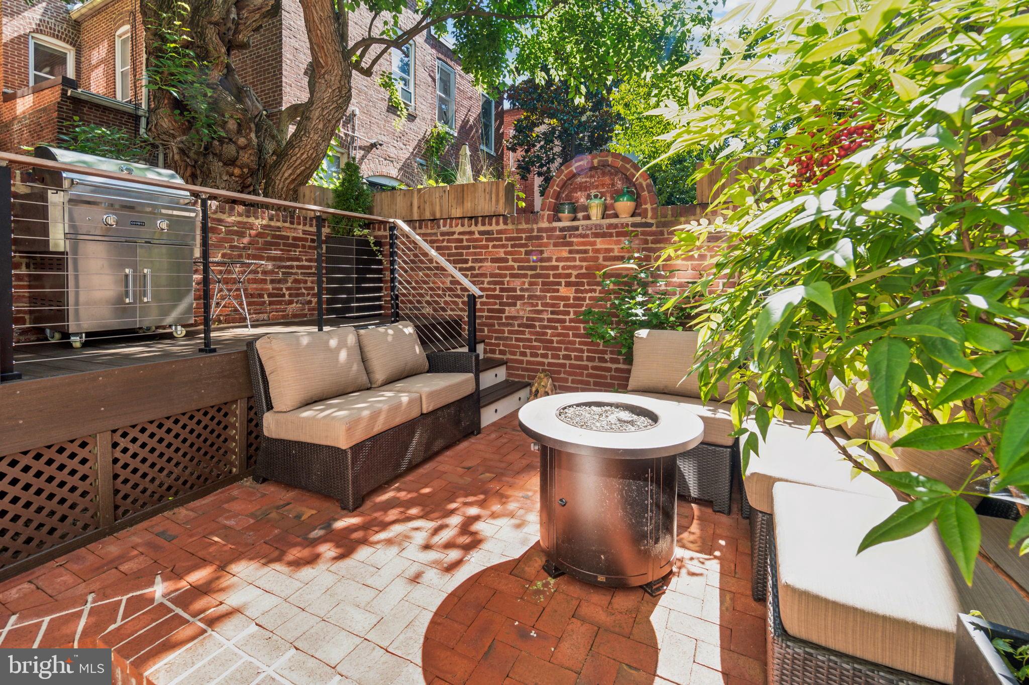 1527 31st Street Northwest Washington, DC 20007 - Photo 29 of 29 a view of a patio with couches table and chairs and potted plants