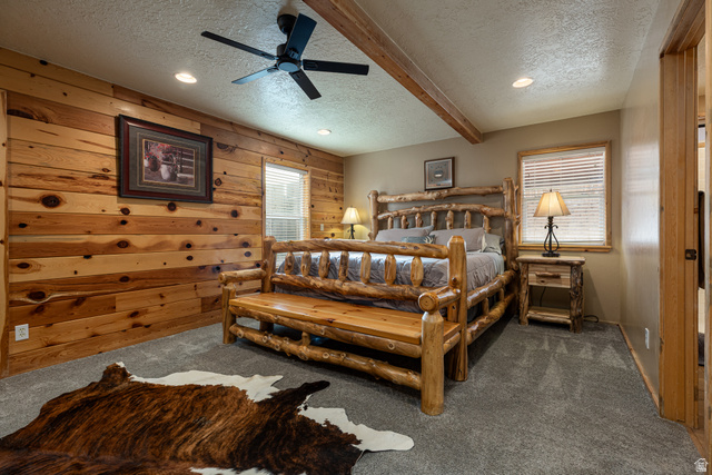 1505 West Elk Ridge Drive Alton, UT 84710 - Photo 10 of 53 Bedroom featuring a textured ceiling, wooden walls, carpet flooring, beam ceiling, and a ceiling fan
