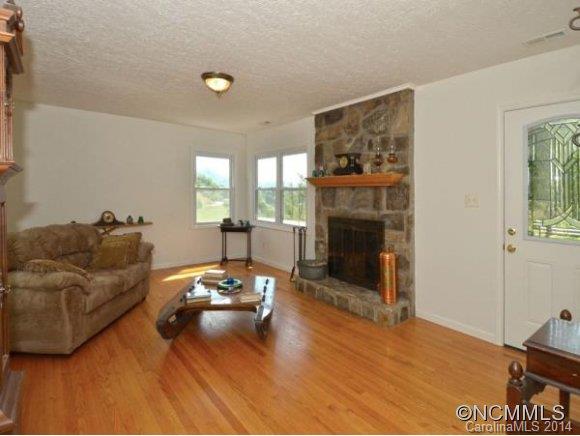 3964 Liner Creek Road Clyde, NC 28721 - Photo 4 of 17 a living room with furniture and a fireplace