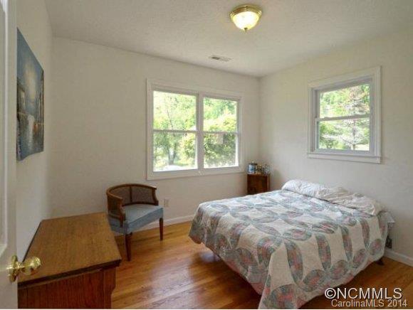 3964 Liner Creek Road Clyde, NC 28721 - Photo 7 of 17 a bed sitting in a bedroom next to a window