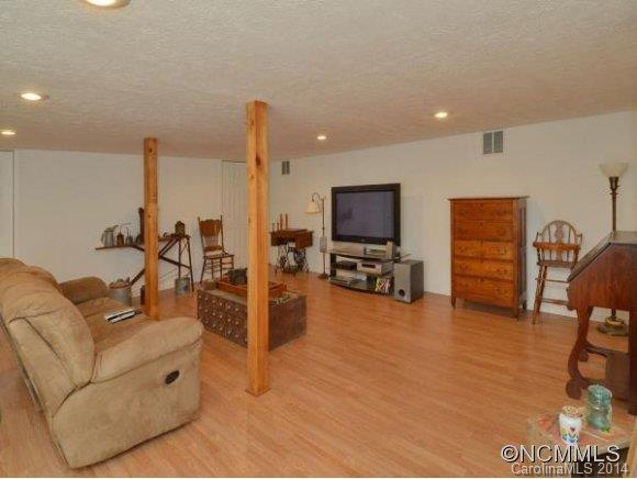 3964 Liner Creek Road Clyde, NC 28721 - Photo 10 of 17 a living room with furniture and a flat screen tv