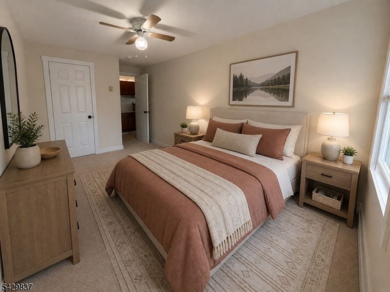 6 Southard Road, Unit 2 Mount Arlington, NJ 07856 - Photo 5 of 10 a bedroom with a bed and a chandelier
