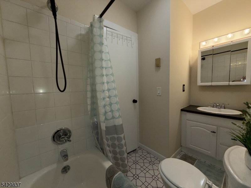 6 Southard Road, Unit 2 Mount Arlington, NJ 07856 - Photo 7 of 10 a bathroom with a granite countertop toilet sink and shower