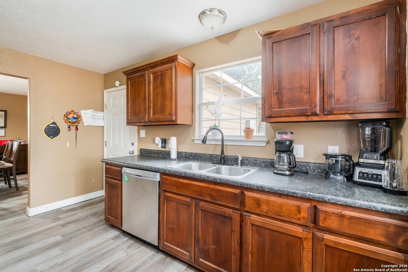 1655 Eichman Road Poteet, TX 78065 - Photo 11 of 45 a kitchen with granite countertop stainless steel appliances a sink window and cabinets