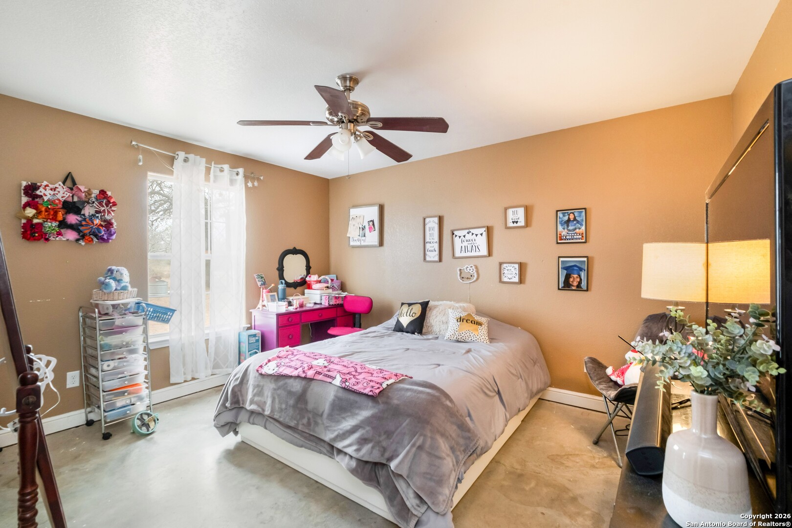 1655 Eichman Road Poteet, TX 78065 - Photo 14 of 45 a bedroom with a bed and a chandelier