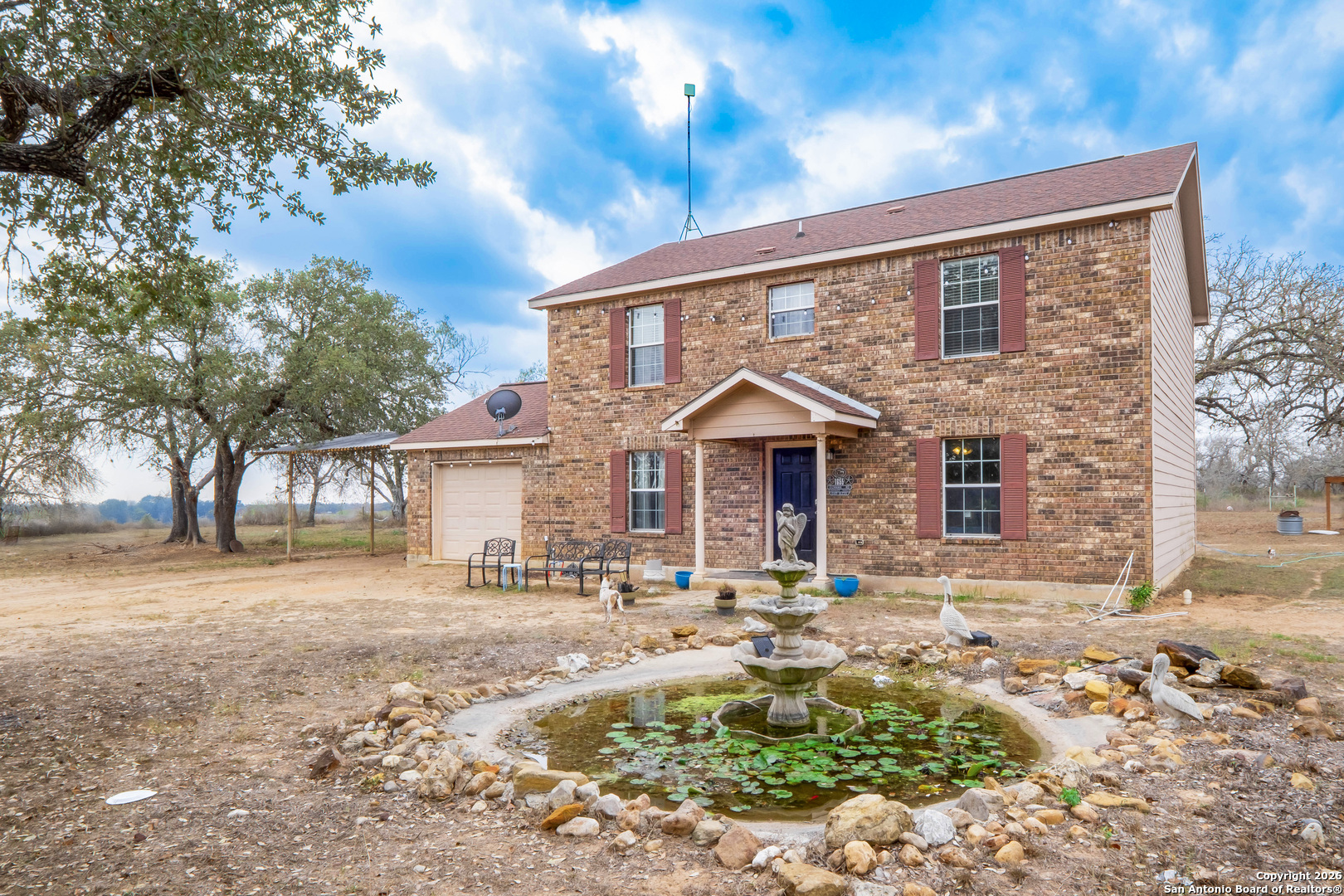 1655 Eichman Road Poteet, TX 78065 - Photo 2 of 45 a front view of a house with a yard