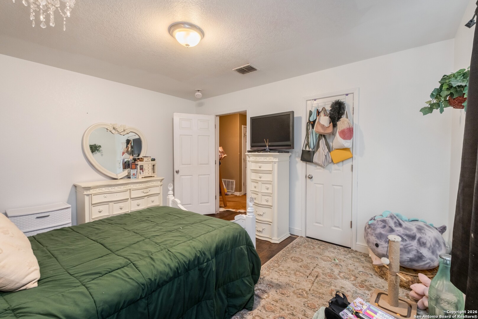 1655 Eichman Road Poteet, TX 78065 - Photo 25 of 45 a bedroom with a bed and cabinets