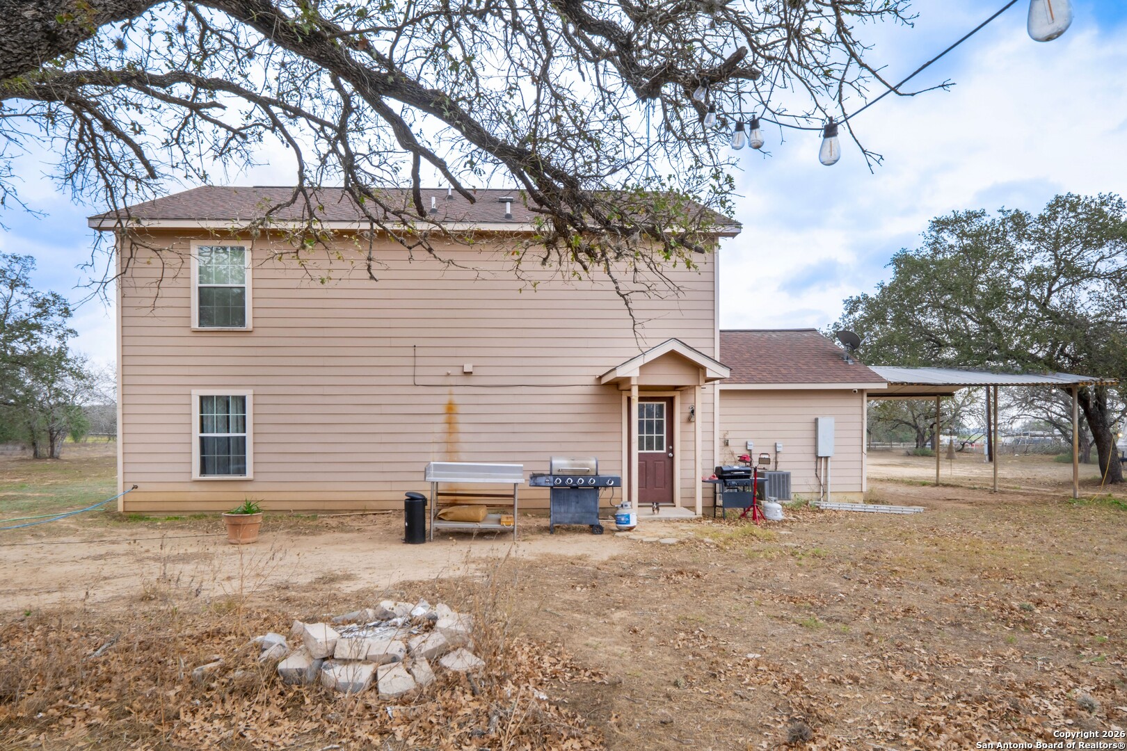1655 Eichman Road Poteet, TX 78065 - Photo 29 of 45 a view of a house with a yard and large tree