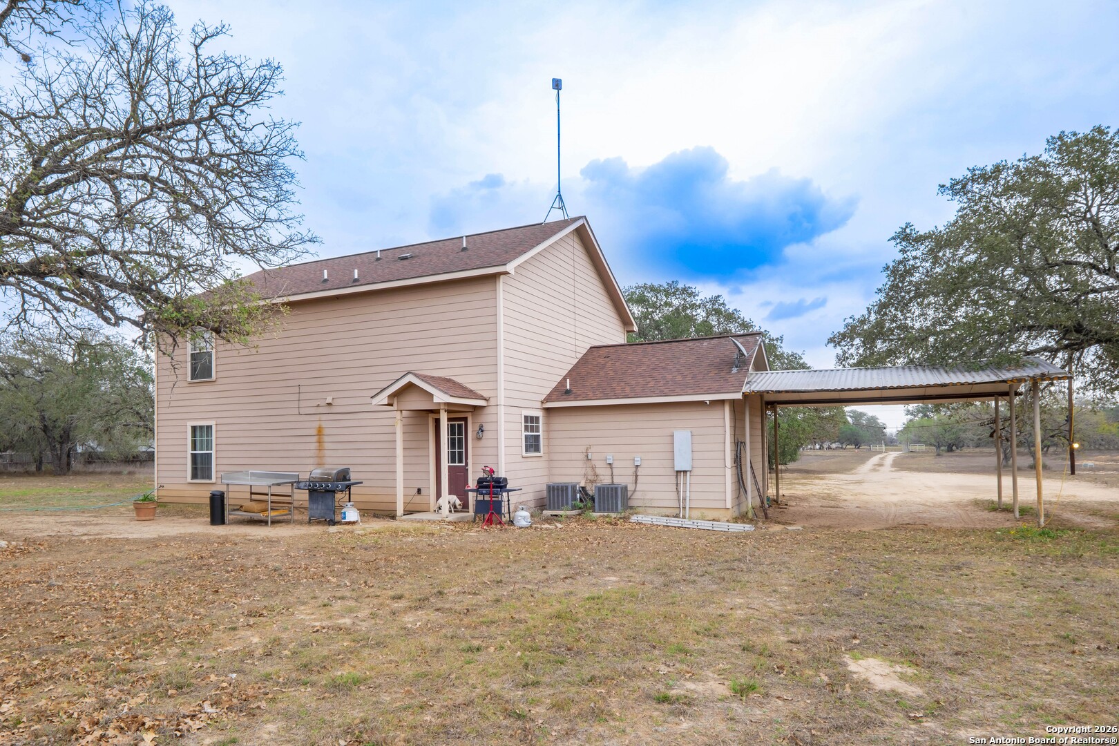 1655 Eichman Road Poteet, TX 78065 - Photo 30 of 45 a view of a house with a yard