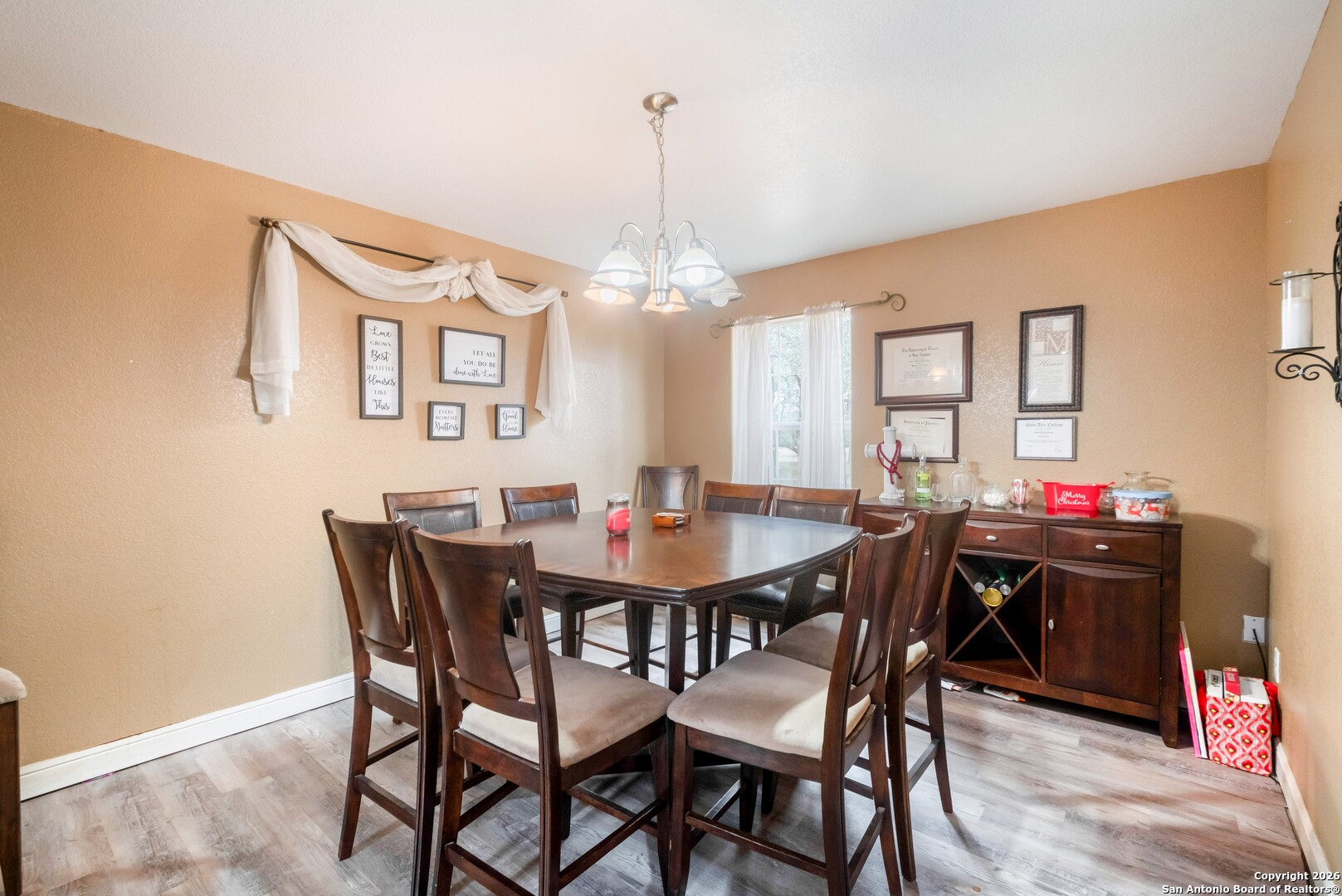 1655 Eichman Road Poteet, TX 78065 - Photo 9 of 45 a view of a dining room with furniture and chandelier