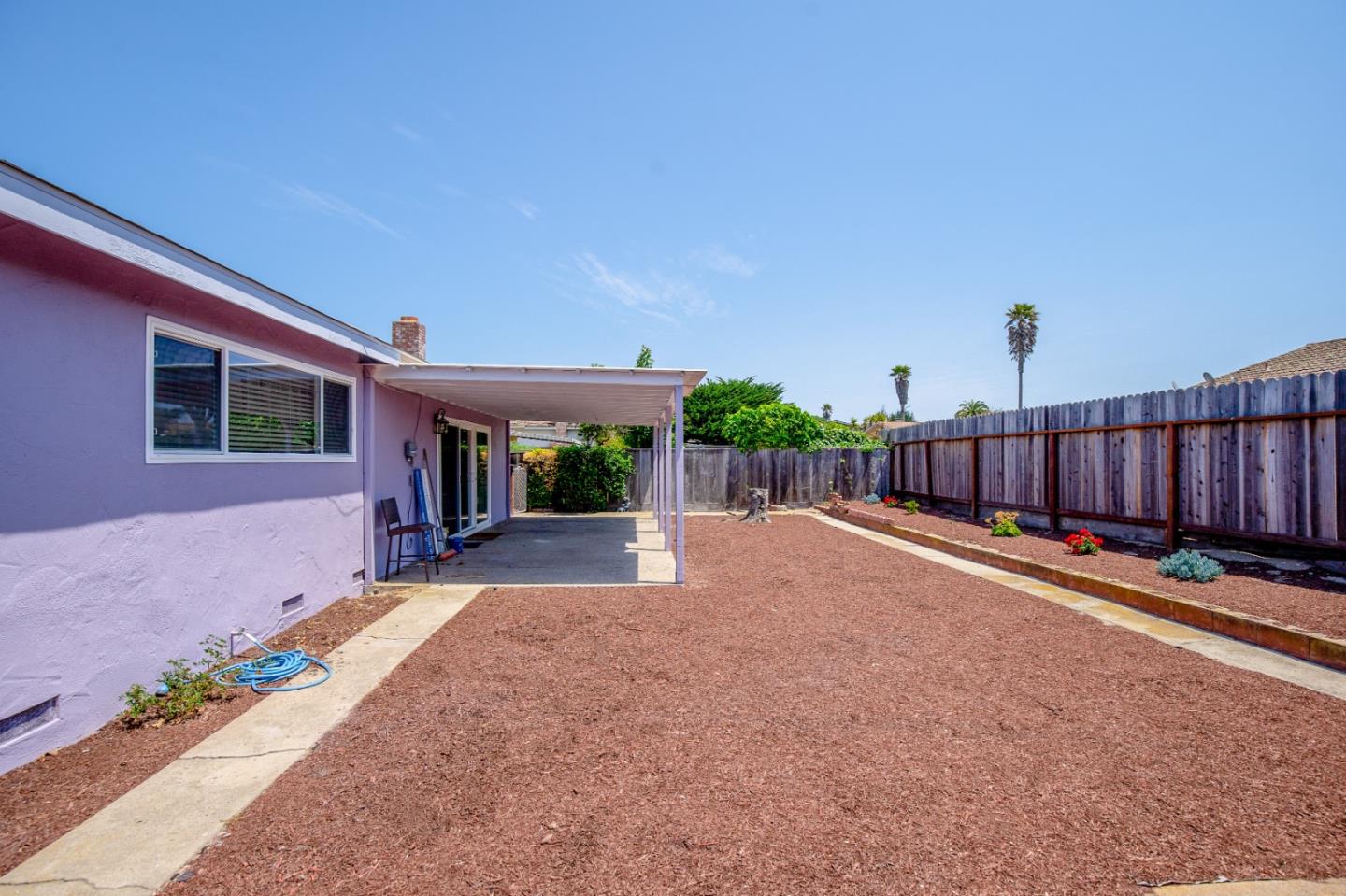 3106 Bradley Circle Marina, CA 93933 - Photo 16 of 16 a view of a backyard with couches plants and wooden fence