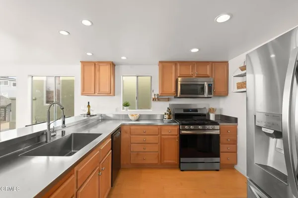 a kitchen with kitchen island granite countertop a sink and cabinets
