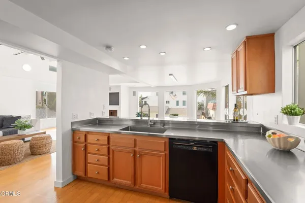 a kitchen with granite countertop a sink stainless steel appliances and cabinets